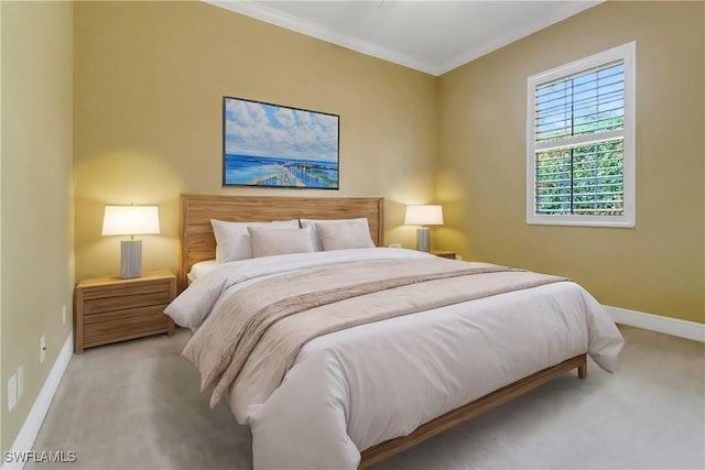 bedroom featuring ornamental molding, light colored carpet, and baseboards