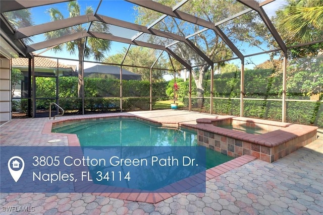 outdoor pool with a lanai, a patio, and an in ground hot tub