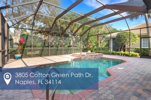 view of swimming pool featuring a pool with connected hot tub, a lanai, and a patio