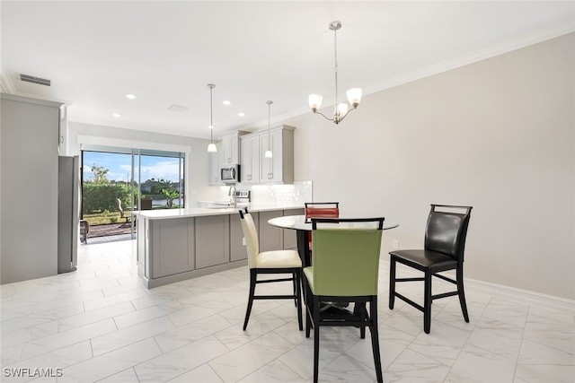 dining space featuring an inviting chandelier and ornamental molding