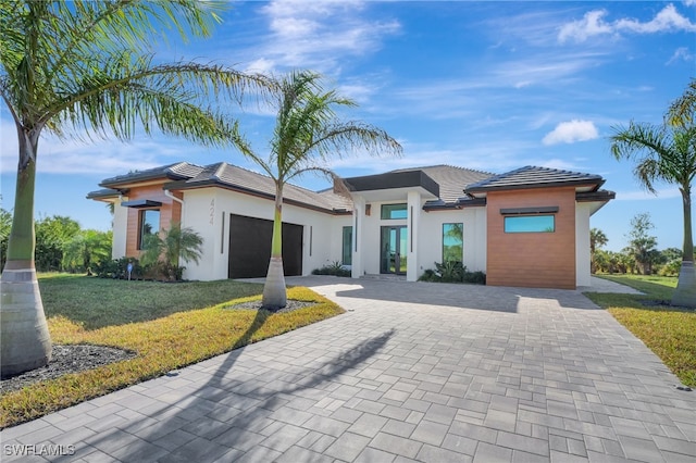 view of front facade featuring a garage and a front lawn