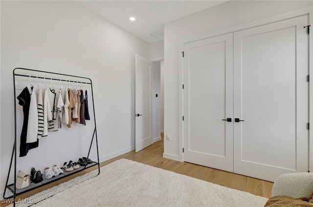 bedroom featuring a closet and light wood-type flooring