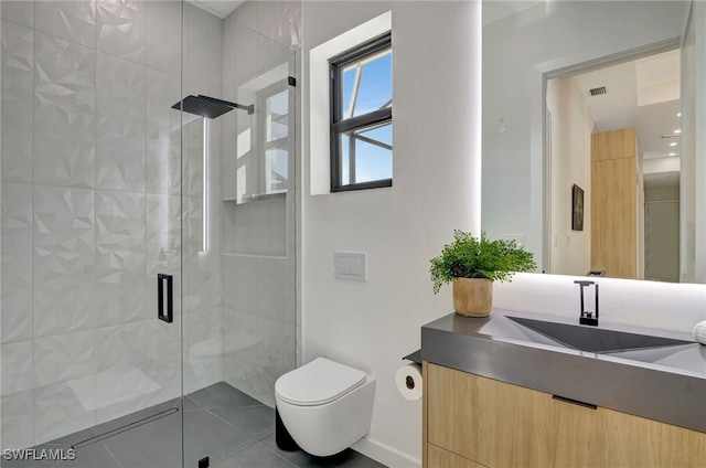 bathroom with vanity, tile patterned floors, a shower with door, and toilet