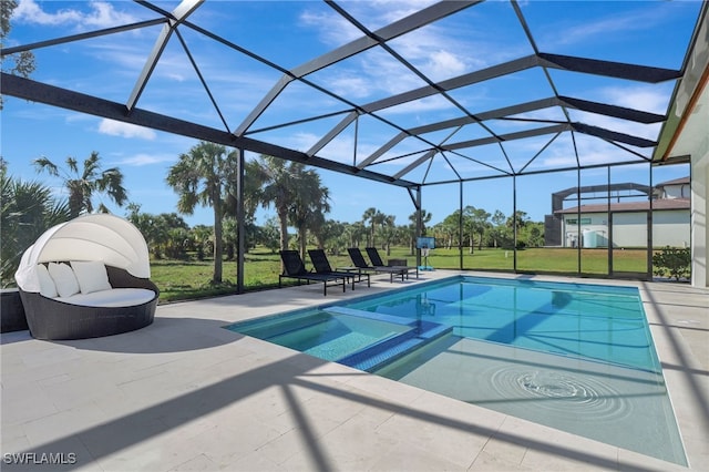 view of pool with a lanai, a patio area, an in ground hot tub, and a lawn