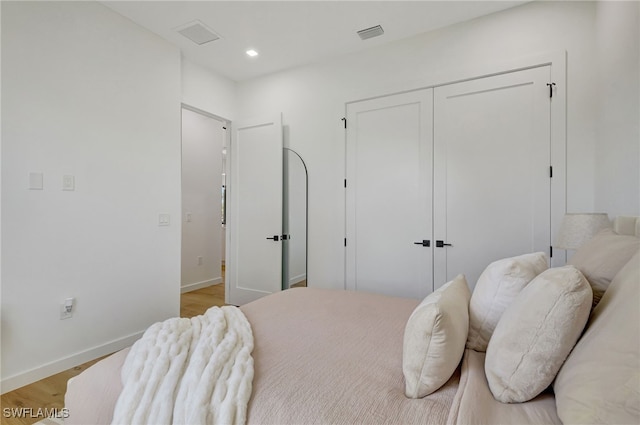 bedroom featuring a closet and light wood-type flooring