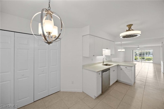 kitchen featuring dishwasher, sink, kitchen peninsula, light tile patterned floors, and white cabinetry