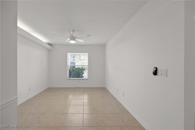 unfurnished room featuring ceiling fan and light tile patterned floors