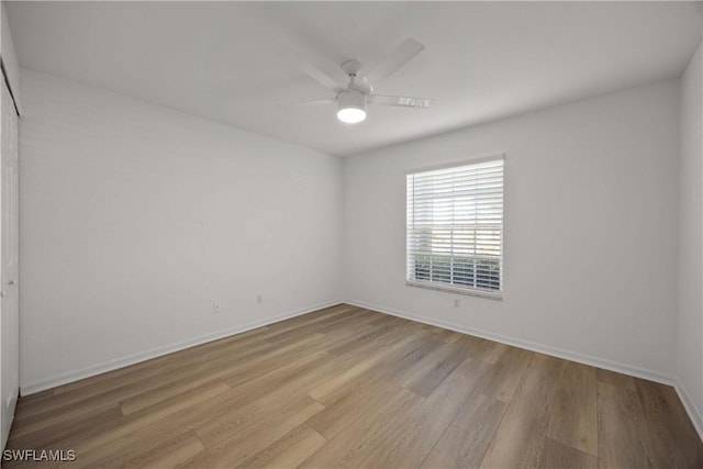 spare room with light hardwood / wood-style flooring and ceiling fan