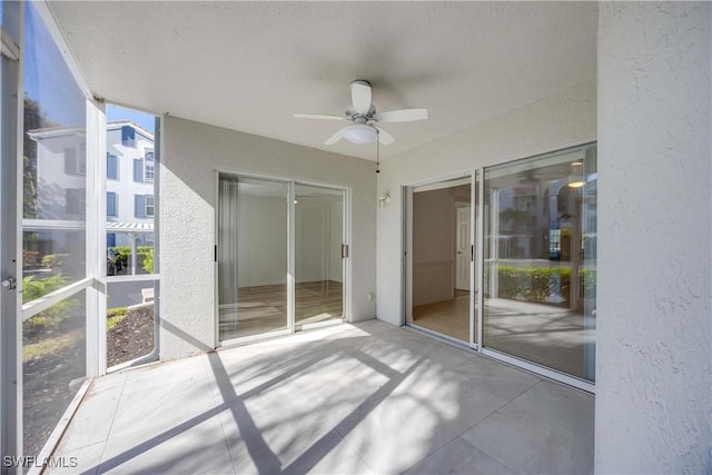 interior space with ceiling fan