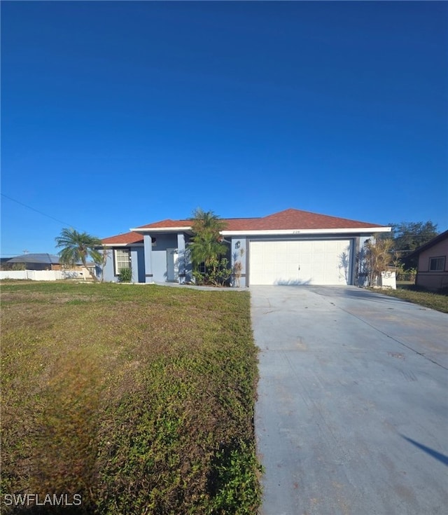 single story home with a garage and a front lawn