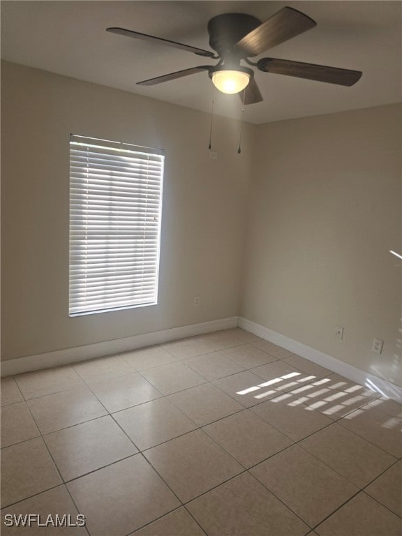 empty room featuring ceiling fan and light tile patterned floors