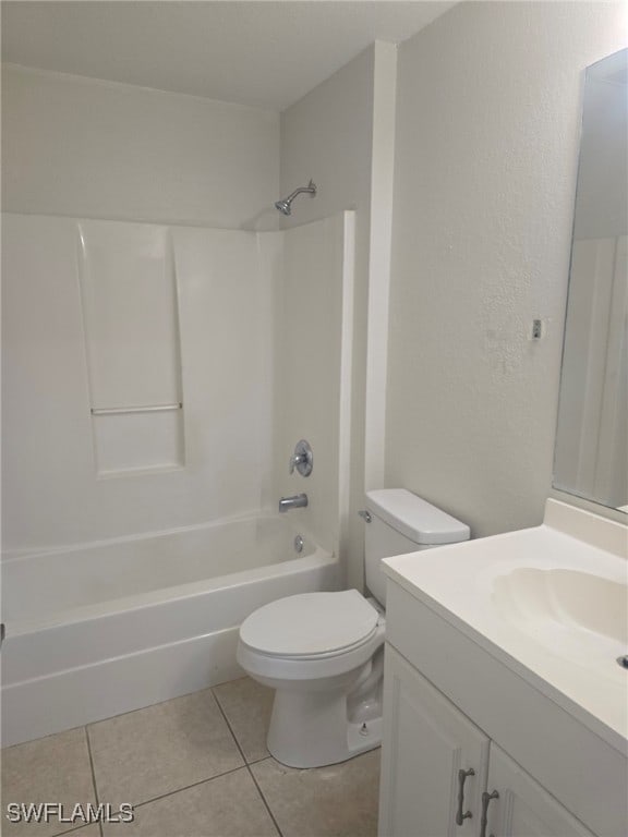 full bathroom with tile patterned flooring, vanity,  shower combination, and toilet