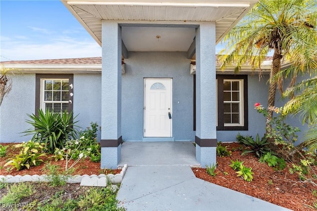 2207 NE 16th Pl, Cape Coral, FL 33909 - doorway to property with stucco siding