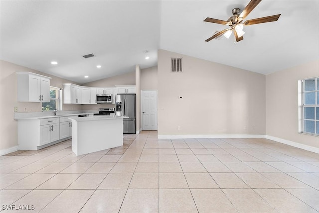 2207 NE 16th Pl, Cape Coral, FL 33909 - kitchen with appliances with stainless steel finishes, light countertops, vaulted ceiling, visible vents, and open floor plan