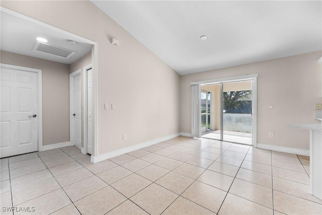 2207 NE 16th Pl, Cape Coral, FL 33909 - empty room with light tile patterned floors, attic access, and baseboards