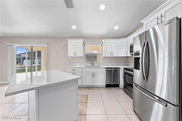 2207 NE 16th Pl, Cape Coral, FL 33909 - kitchen featuring light tile patterned flooring, visible vents, white cabinetry, and stainless steel appliances