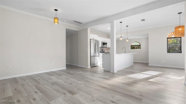 unfurnished living room with sink, light wood-type flooring, and ornamental molding