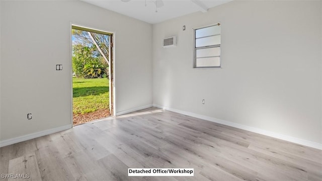 empty room with light hardwood / wood-style flooring and ceiling fan