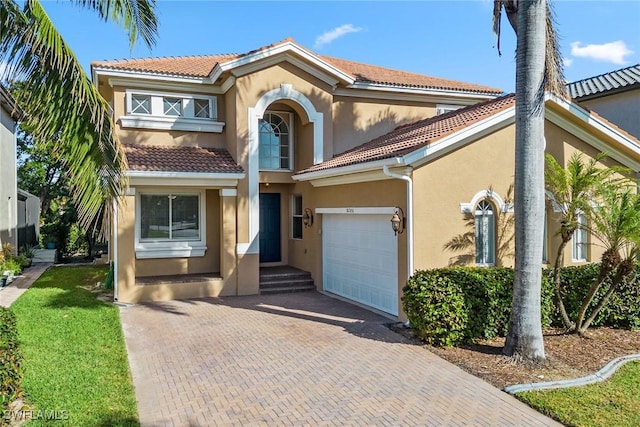 mediterranean / spanish-style home with a garage