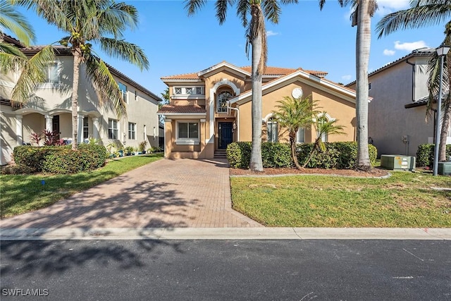 mediterranean / spanish-style house featuring a front lawn