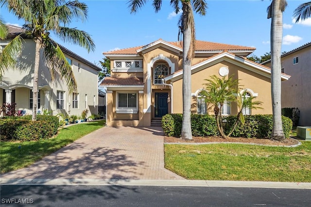 mediterranean / spanish house featuring a front yard