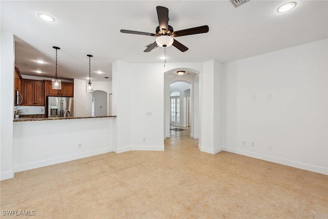 unfurnished living room featuring ceiling fan