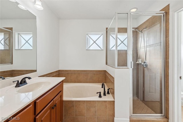 bathroom with vanity and separate shower and tub