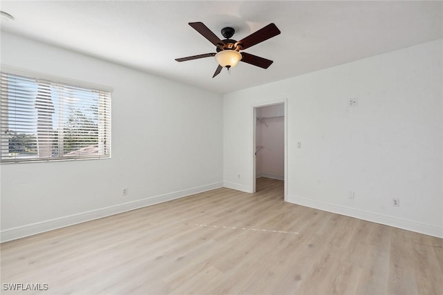 unfurnished room with ceiling fan and light wood-type flooring