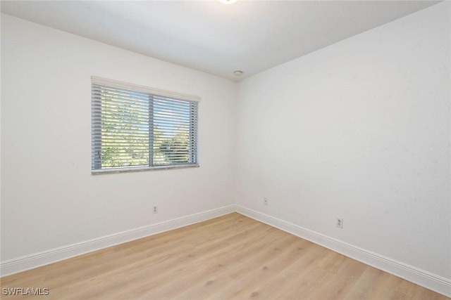 empty room with light hardwood / wood-style flooring