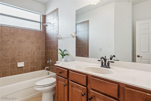 full bathroom with vanity, tiled shower / bath combo, and toilet