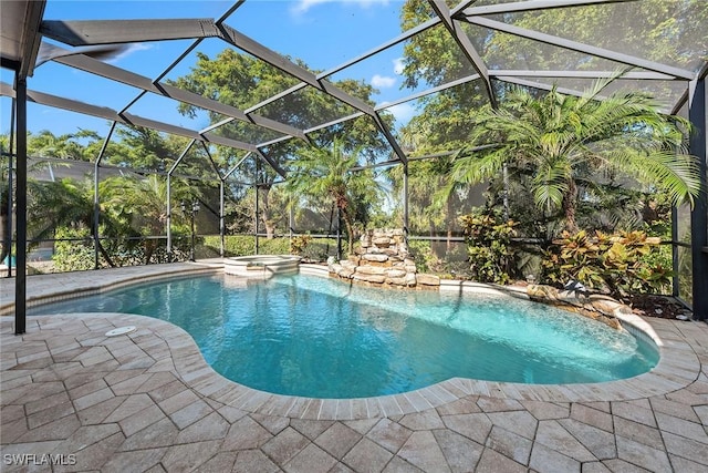 view of pool featuring an in ground hot tub, a patio, and a lanai