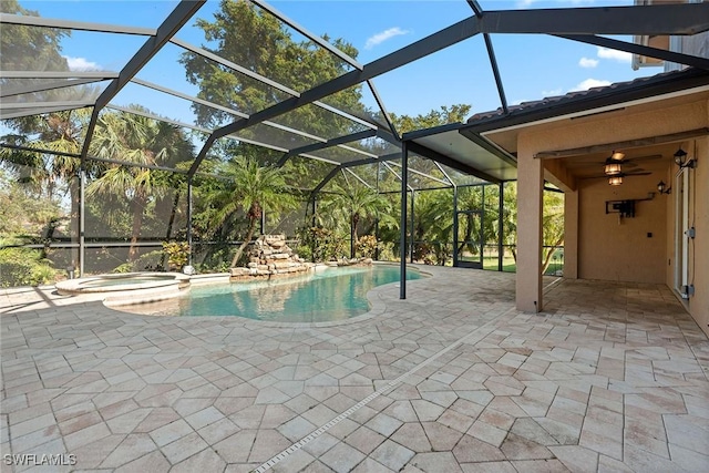 view of pool with an in ground hot tub, a patio, and glass enclosure