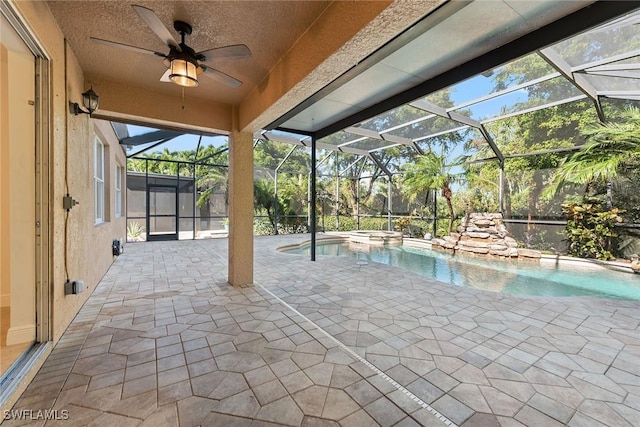 view of swimming pool with ceiling fan, a patio area, and a lanai