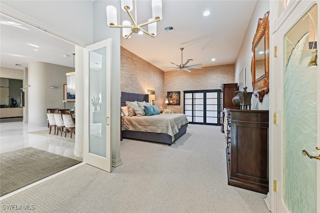 carpeted bedroom with an inviting chandelier and french doors