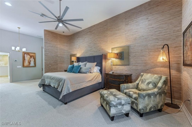 carpeted bedroom with ceiling fan with notable chandelier