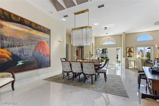 dining space featuring light tile patterned floors and a notable chandelier