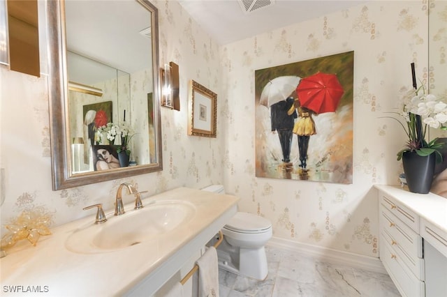 bathroom with vanity and toilet