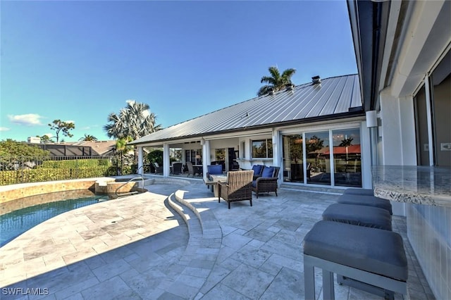 view of patio with a swimming pool with hot tub and an outdoor living space