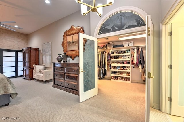 bedroom with carpet flooring, a chandelier, french doors, and a closet