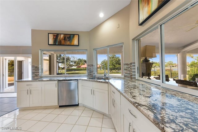 kitchen featuring white cabinets, light tile patterned flooring, sink, and tasteful backsplash