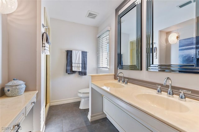 bathroom with tile patterned floors, vanity, and toilet