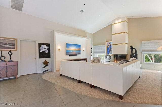 tiled living room with high vaulted ceiling