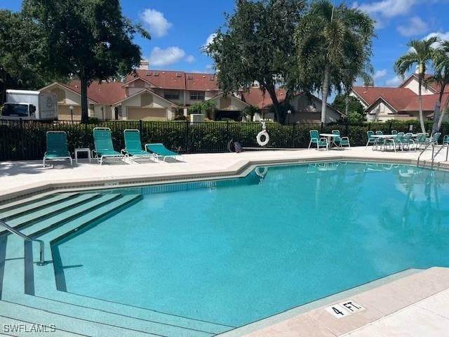 20190 Golden Panther Dr Unit 3, Estero, FL 33928 - community pool featuring a patio and a residential view