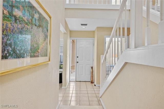 foyer featuring a healthy amount of sunlight and light tile patterned floors