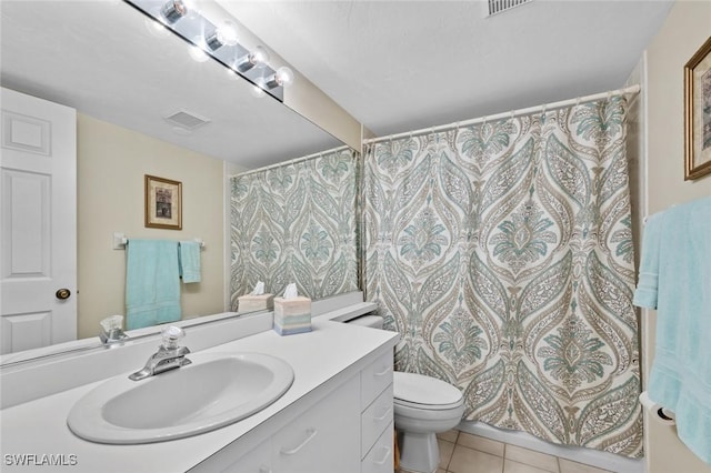 bathroom with tile patterned floors, vanity, and toilet