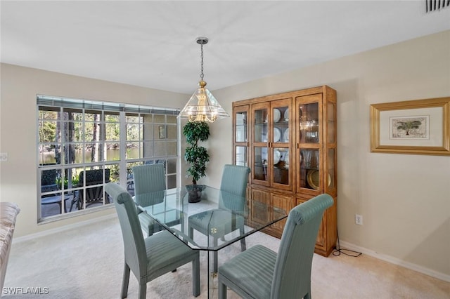 dining space featuring light colored carpet