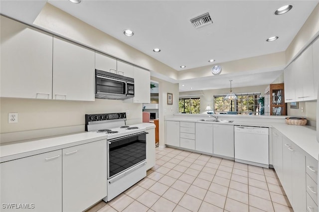 20190 Golden Panther Dr Unit 3, Estero, FL 33928 - kitchen featuring white appliances, light countertops, white cabinetry, recessed lighting, and light tile patterned floors