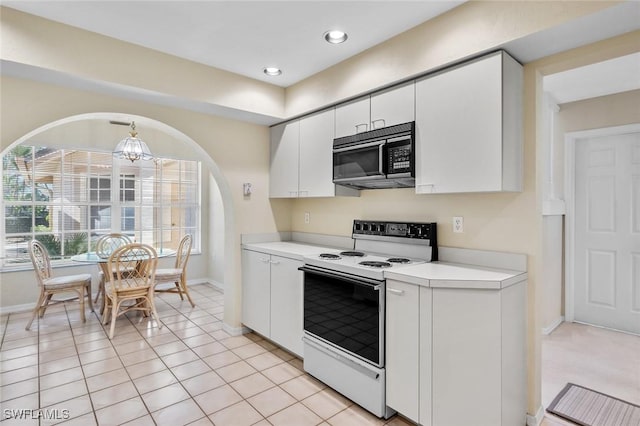 kitchen featuring white cabinets, white range with electric stovetop, and light tile patterned floors