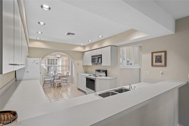 kitchen with white cabinetry, light tile patterned flooring, white appliances, and sink