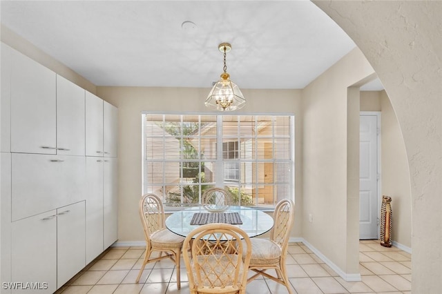 20190 Golden Panther Dr Unit 3, Estero, FL 33928 - dining space with a chandelier, light tile patterned floors, and arched walkways